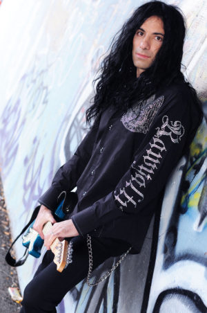 Mike Campese Promo. Leaning on a painted wall.