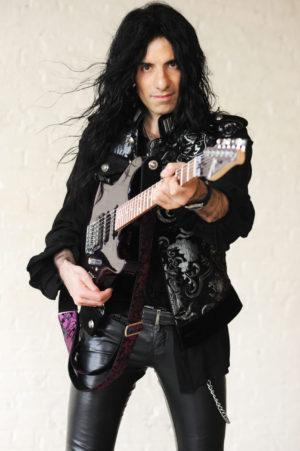 Mike Campese Promo Pic. Purple Guitar, pointing.