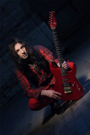 Mike Campese, Red Guitar and Outfit. Kneeling.
